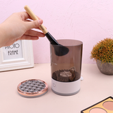 Everyday Needs and Wants makeup brush cleaner bottle with cleaning solution and brush for makeup brush cleaning.
