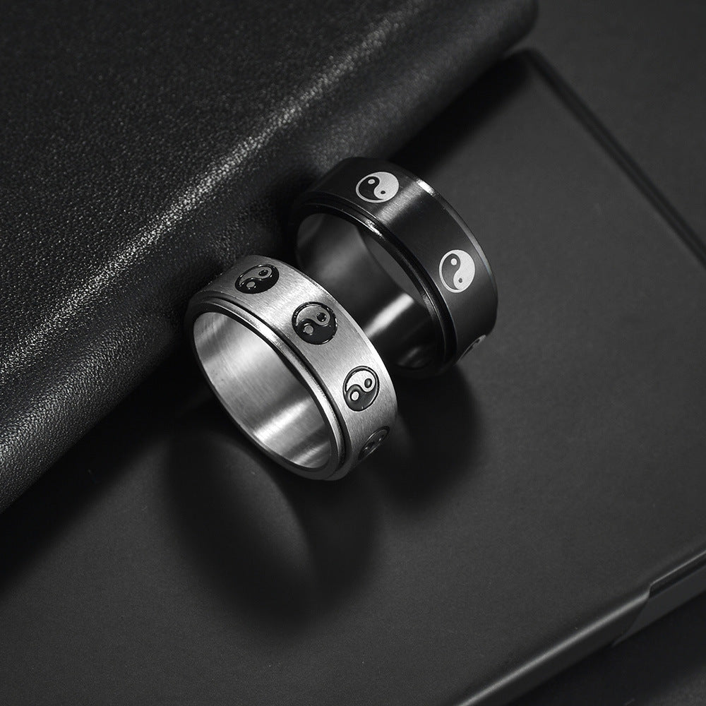 Stainless steel turning decompression gossip ring with intricate design, worn on finger for stress relief and style.