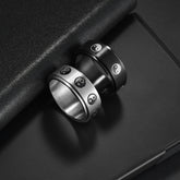 Stainless steel turning decompression gossip ring with intricate design, worn on finger for stress relief and style.