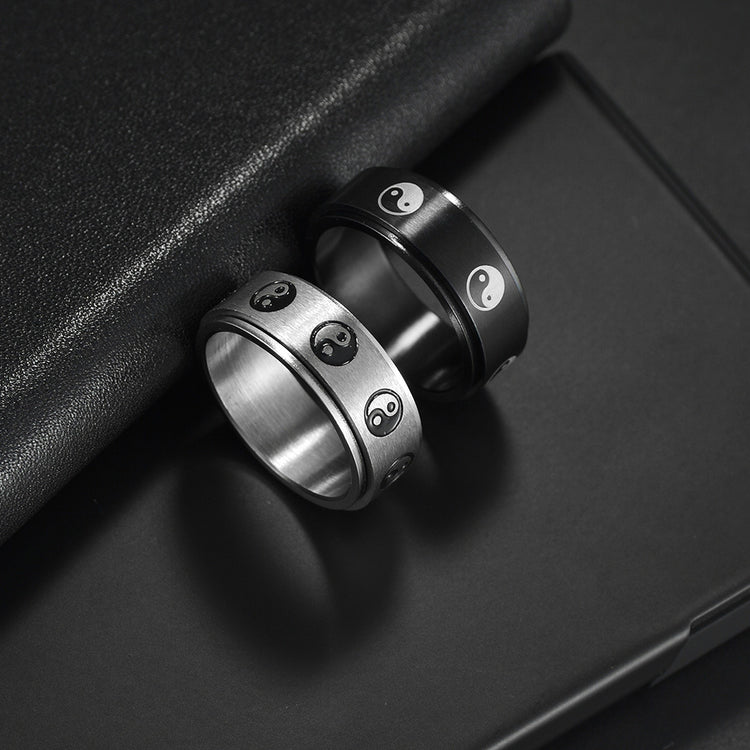 Stainless steel turning decompression gossip ring with intricate design, worn on finger for stress relief and style.