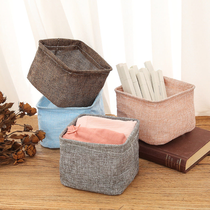 Mini cotton and linen storage basket for desk organization, by Everyday Needs and Wants, with a soft, woven fabric appearance.