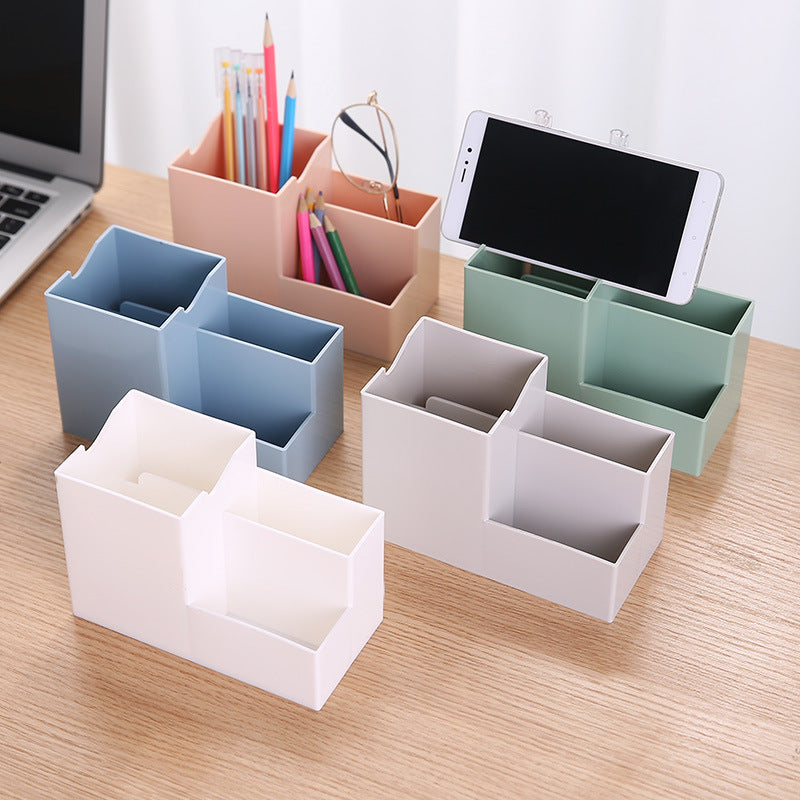Multifunctional pen holder and remote storage box by Everyday Needs and Wants, with compartments for pens, remote controls, and small accessories.