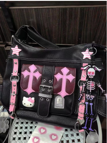 Sanrio Kitty black and pink colorblock crossbody bag with adjustable strap and cute character detail.